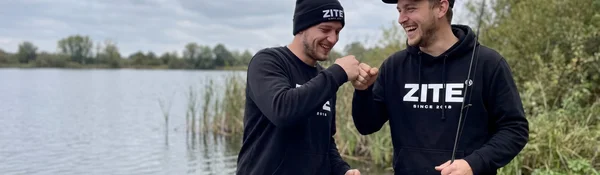 Zwei junge Angler in Zite-Merch feiern am See — die Zite-Community